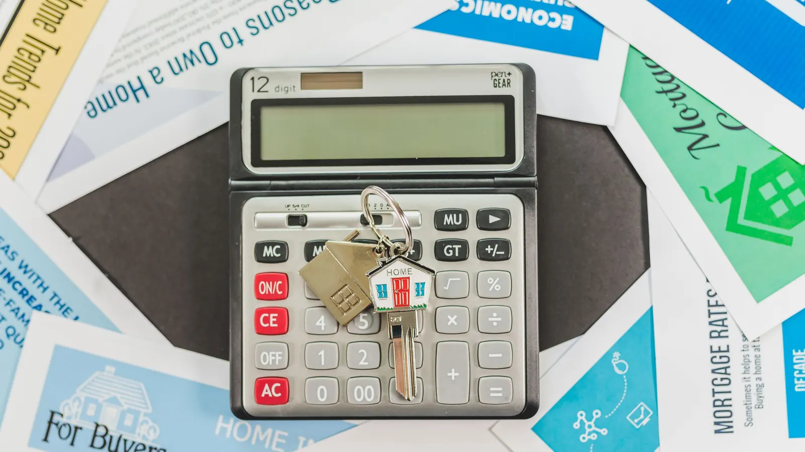 A calculator and house keys resting on home loan leaflets